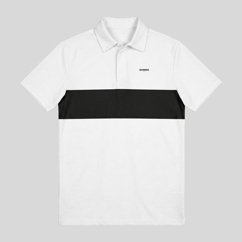 Flat lay front view of a white men's golf polo with a black chest stripe and small black Unanimous Golf logo, on a light grey background.