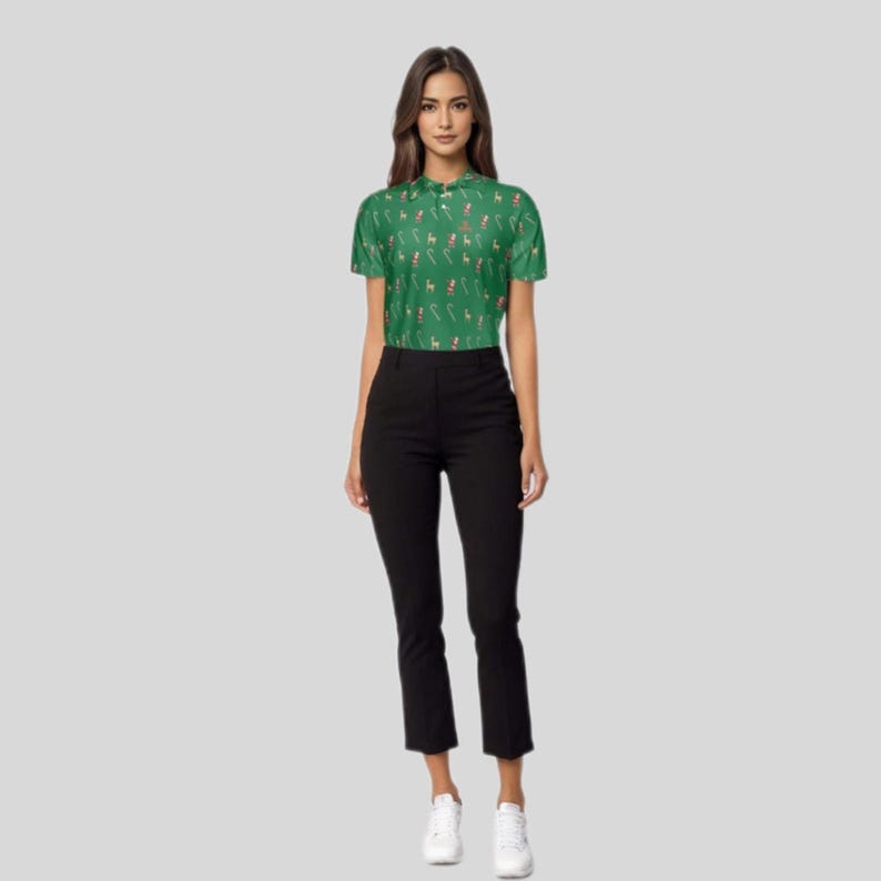 Full-length view of a model standing in the green holiday golf polo and black trousers.