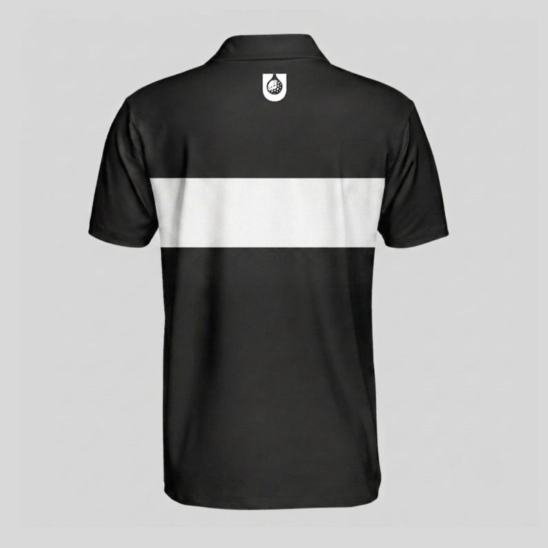 Back view of a black men's golf polo with a white chest stripe and white golf ball emblem printed below the collar.