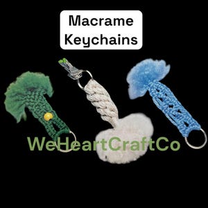 May include: Three macrame keychains in green, white, and blue. The green keychain has a yellow bead. The white keychain has a braided design. The blue keychain has a woven pattern. Text on the image reads "Macrame Keychains" and "WeHeartCraftCo".