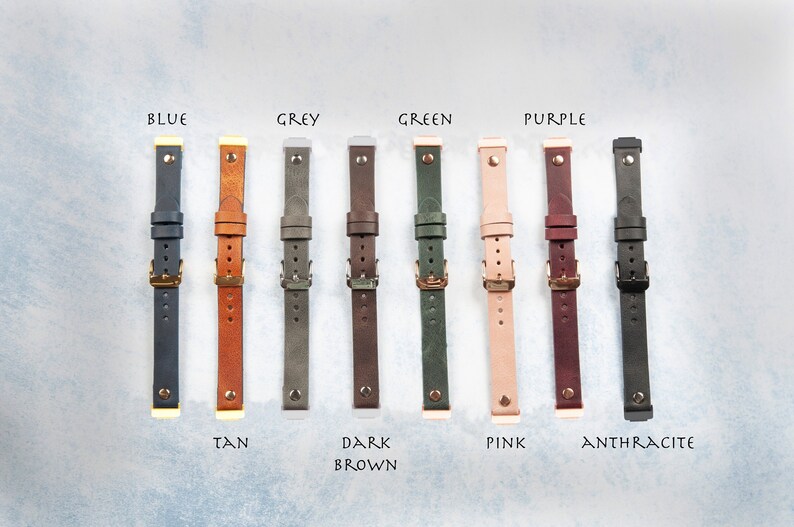 May include: A collection of leather watch straps in various colors, including blue, tan, grey, dark brown, green, pink, purple, and anthracite. Each strap features a buckle and is labeled with its color name.