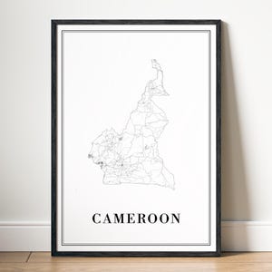 May include: A black and white map of Cameroon with the country name printed below. The map is framed in a black frame.