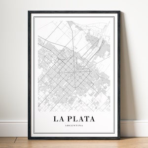 May include: Black framed print of a detailed map of La Plata, Argentina. The map is in black and white, showing streets and urban areas. The city name and country are printed in a clean, modern font at the bottom of the print.