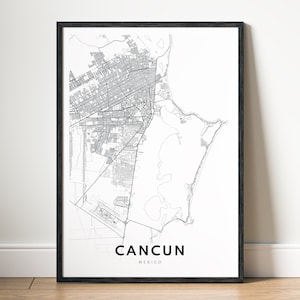 May include: Black and white map print of Cancun, Mexico, in a black frame. The map shows the city's streets and coastline.