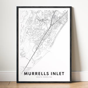 May include: A framed black and white map print of Murrells Inlet, South Carolina. The map details the coastal area with roads and waterways. The text "MURRELLS INLET SOUTH CAROLINA" is printed at the bottom of the print.