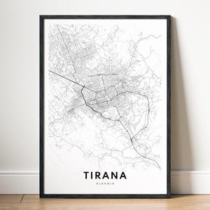 Può includere: Una stampa artistica incorniciata con una mappa stradale in bianco e nero di Tirana, Albania. La mappa mostra intricate reti stradali in sottili linee nere su sfondo bianco, con il testo TIRANA ALBANIA stampato in grassetto nero.
