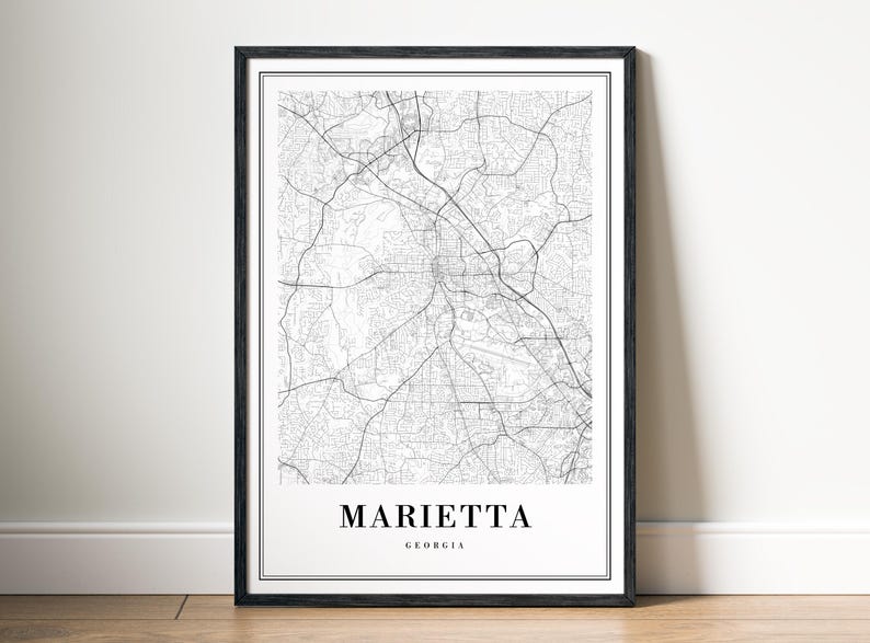 May include: Black and white map print of Marietta, Georgia in a black frame. The map shows the city streets and roads.