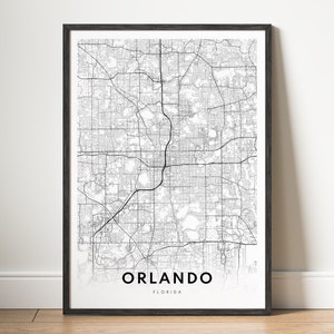 Puede incluir: Una impresión de mapa en blanco y negro de Orlando, Florida, en un marco negro. El mapa muestra las calles y carreteras de la ciudad.