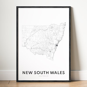 May include: A black and white line art map of New South Wales, Australia, printed on white paper and framed in a black frame.