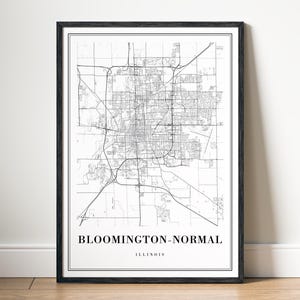 May include: A framed black and white map print of Bloomington-Normal, Illinois. The detailed map shows streets and infrastructure. The text "BLOOMINGTON-NORMAL ILLINOIS" is centered at the bottom of the print.