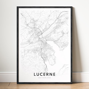 May include: A black and white map print of Lucerne, Switzerland. The map shows the city's streets and waterways. The city name is printed in bold at the bottom of the map.