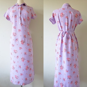 May include: A lavender midi dress with a floral print and a tie at the waist.