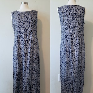 May include: A sleeveless maxi dress with a blue background and a white floral pattern.