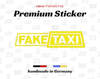 May include: A yellow and white "FAKE TAXI" sticker with the text "Premium Sticker" and "handmade in Germany". The sticker has a taxi cab design with the words "FAKE TAXI" in bold white letters.
