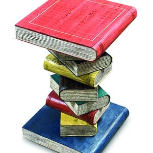 May include: A decorative side table shaped like a vertical stack of six books. The top book is red, followed by yellow, dark green, red, yellow, and a large blue book at the base. Each book features visible page edges and a textured, painted finish.