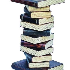 May include: A decorative side table constructed from a vertical stack of dark brown books with visible page edges. The structure features a wide base book and a flat top book, with several smaller, staggered books forming the central column support.