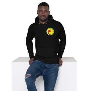 May include: Black hoodie with a green, yellow, and red circle logo on the left chest. The logo features a stylized image of a hand holding a torch.