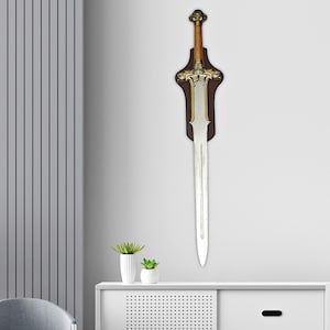 May include: A decorative sword mounted on a dark brown wooden wall plaque. The sword features a metallic silver blade, a gold-toned crossguard with intricate detailing, a brown leather-wrapped grip, and a circular pommel with a face design.