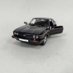 May include: A black model car with an open door, displaying a Ford badge on the front. The car has a red and white stripe along the side and the text "Your Plate" on the license plate.