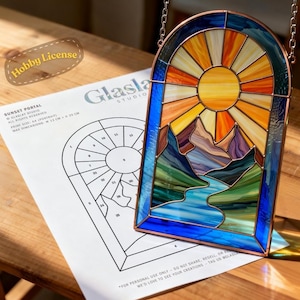 May include: Stained glass panel depicting a sunset over mountains and a river, with a copper frame and hanging chain. The panel is next to a printed pattern labeled "Sunset Portal" with dimensions of 12 cm x 20 cm.