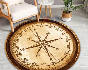 May include: A round rug with a compass design. The rug features a compass rose in the center, with directional markings and degree indicators around the edge. The color scheme is primarily brown and beige, with a vintage aesthetic.