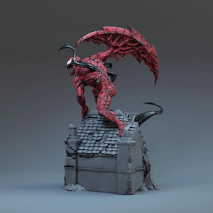 Puede incluir: Estatua roja y negra de una figura monstruosa con grandes alas, posada sobre un edificio gris. La figura tiene una apariencia detallada y texturizada, con garras afiladas y una expresión amenazante. Las alas son de un rojo intenso con detalles negros.