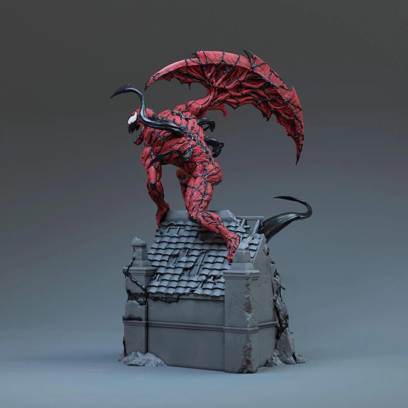 May include: A red and black statue of a monstrous figure with large wings, perched atop a gray building. The figure has a detailed, textured appearance, with sharp claws and a menacing expression. The wings are a deep red with black accents.