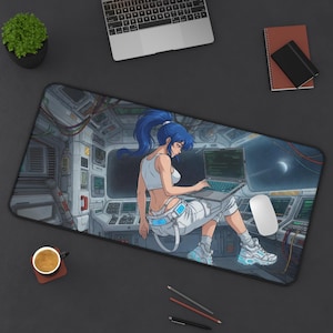 May include: A rectangular desk mat featuring an anime-style illustration of a person with blue hair sitting in a futuristic spaceship cockpit, using a laptop. The scene includes control panels, exposed wiring, and a view of space through a large window.