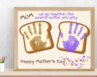 May include: A framed Mother's Day card with a handprint design. The card says "MOM we go together like peanut butter and jelly" and "Happy Mother's Day".