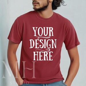 May include: A red t-shirt with the text "YOUR DESIGN HERE" in white.