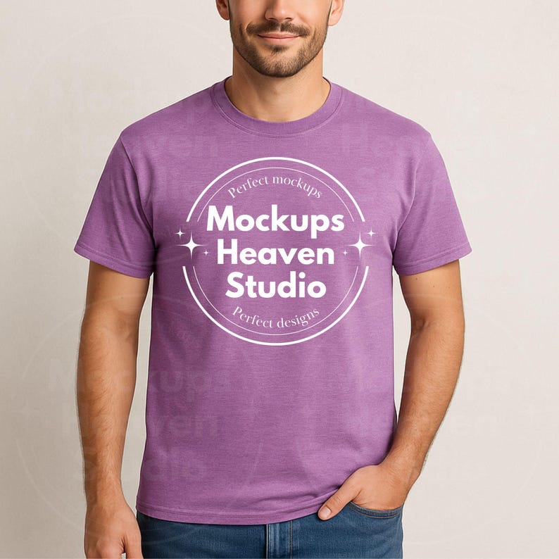 May include: A heather purple crew neck t-shirt with the text "Mockups Heaven Studio" in a white circular design. The shirt is a solid color and has short sleeves.