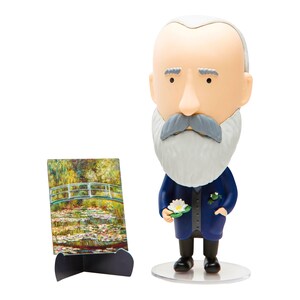 May include: A blue and white figurine of a man with a white beard and mustache holding a white water lily. The figurine is standing on a clear plastic base. Behind the figurine is a small picture frame with a painting of a bridge over a pond with water lilies.