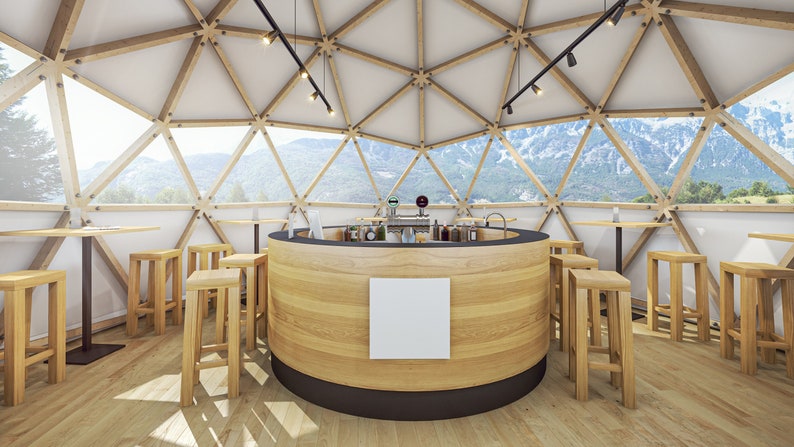 May include: A wooden bar counter with stools in a geodesic dome structure with large windows overlooking a mountain landscape.