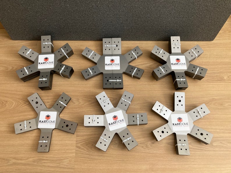 May include: Six gray metal star-shaped connectors with the text "KASTDOME" printed on each. The connectors are stacked on top of each other.