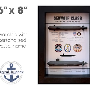 May include: A framed 6x8 inch print of a Seawolf Class Nuclear Submarine. The print features a black and white illustration of the submarine, along with details about its specifications, including displacement, propulsion, speed, test depth, complement, range, cost, built, in commission, and armament. The print also includes three small, colorful illustrations of the submarine's insignia.