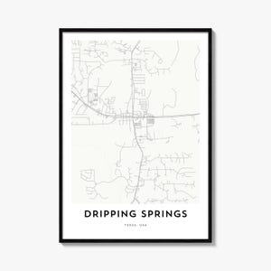 May include: A framed map print of Dripping Springs, Texas, USA, featuring a minimalist white background with grey lines representing roads and infrastructure, with the text Dripping Springs and Texas, USA printed in black at the bottom.