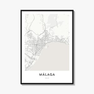 May include: A framed wall art print featuring a minimalist map of Málaga, Spain. The map displays grey street networks against a light grey background, with the text MÁLAGA and SPAIN printed in black at the bottom center of the white border.