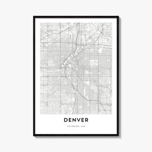 May include: A framed wall art print featuring a detailed grey and white street map of Denver, Colorado, USA. The map displays a complex grid of roads and highways. Below the map, the text reads DENVER and COLORADO, USA in black capital letters.