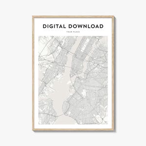 May include: A framed digital download print featuring a detailed map of a city, rendered in shades of gray. The text "DIGITAL DOWNLOAD" and "YOUR PLACE" are at the top. The print is encased in a light-colored wooden frame.