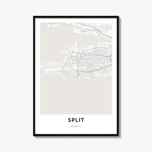 May include: A framed wall art print featuring a minimalist map of Split, Croatia. The design displays grey street lines on a light beige background, with the text SPLIT and CROATIA printed in bold black capital letters at the bottom center.