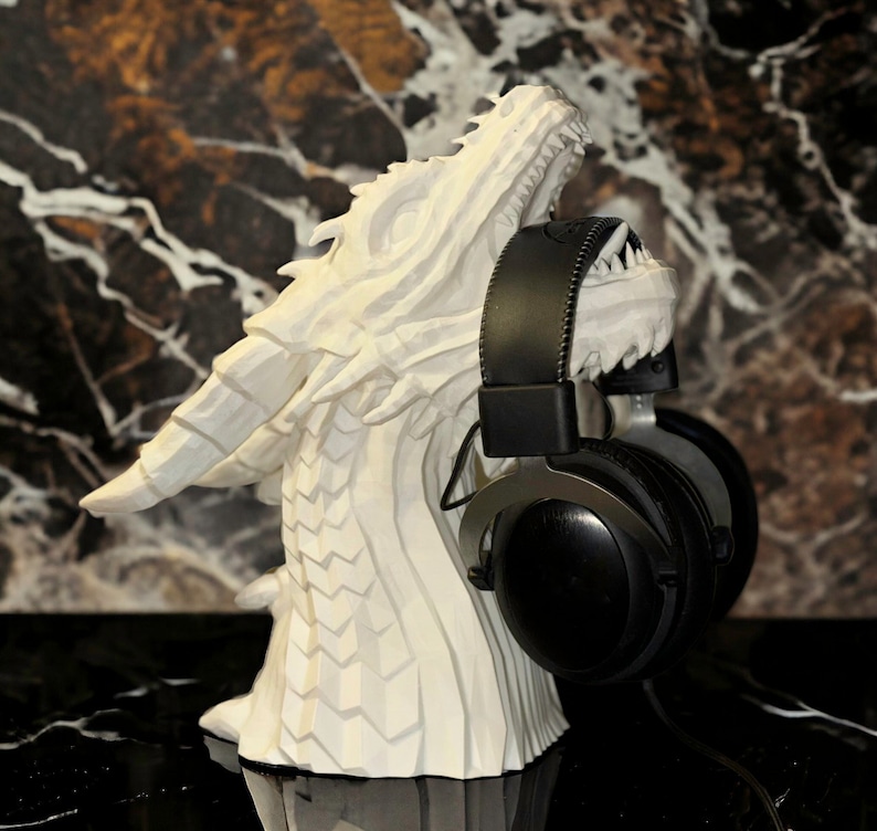 white dragon headphones holder with headphones in its mouth