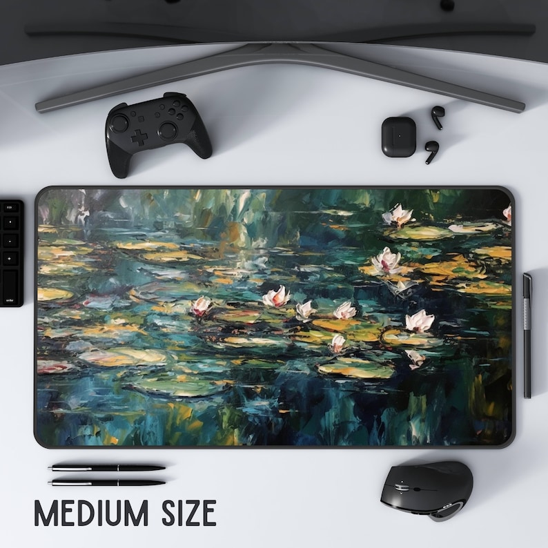 May include: A green and blue abstract painting of water lilies on a pond. The painting is on a black mouse pad with the text "MEDIUM SIZE" printed below it.