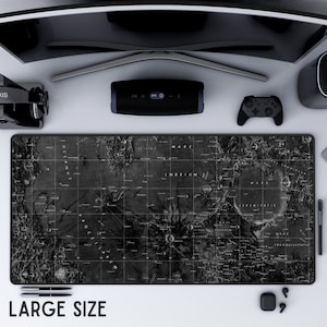 May include: A large, rectangular black and white desk mat featuring a detailed map of the moon's surface. The mat includes labeled lunar features and grid lines. The words "LARGE SIZE" are printed at the bottom. Other desk accessories are visible.
