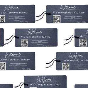 May include: A set of eight black slate welcome tags with white text and a QR code. The text reads "Welcome, We're so glad you're here".