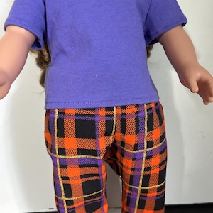 Purple t-shirt with orange, black and purple plaid pants for 18 inch dolls.