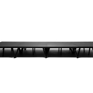 May include: Black stage platform with multiple adjustable legs. The platform is made of wood and has a black finish.