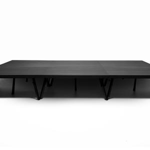 May include: Black wooden stage platform with a series of black metal legs.