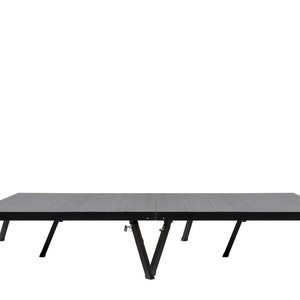 May include: A black folding table with a rectangular tabletop and angled legs. The tabletop has a wood grain appearance. The legs are made of black metal. The table is designed to be portable and easy to set up.