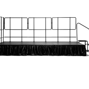 May include: Black stage with a black skirt and a black metal railing with a set of stairs on the right side.