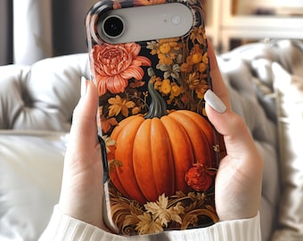 May include: A smartphone case featuring a vibrant orange pumpkin as the central focus, surrounded by detailed illustrations of autumn leaves, golden yellow flowers, and deep red blossoms set against a dark, moody black background.